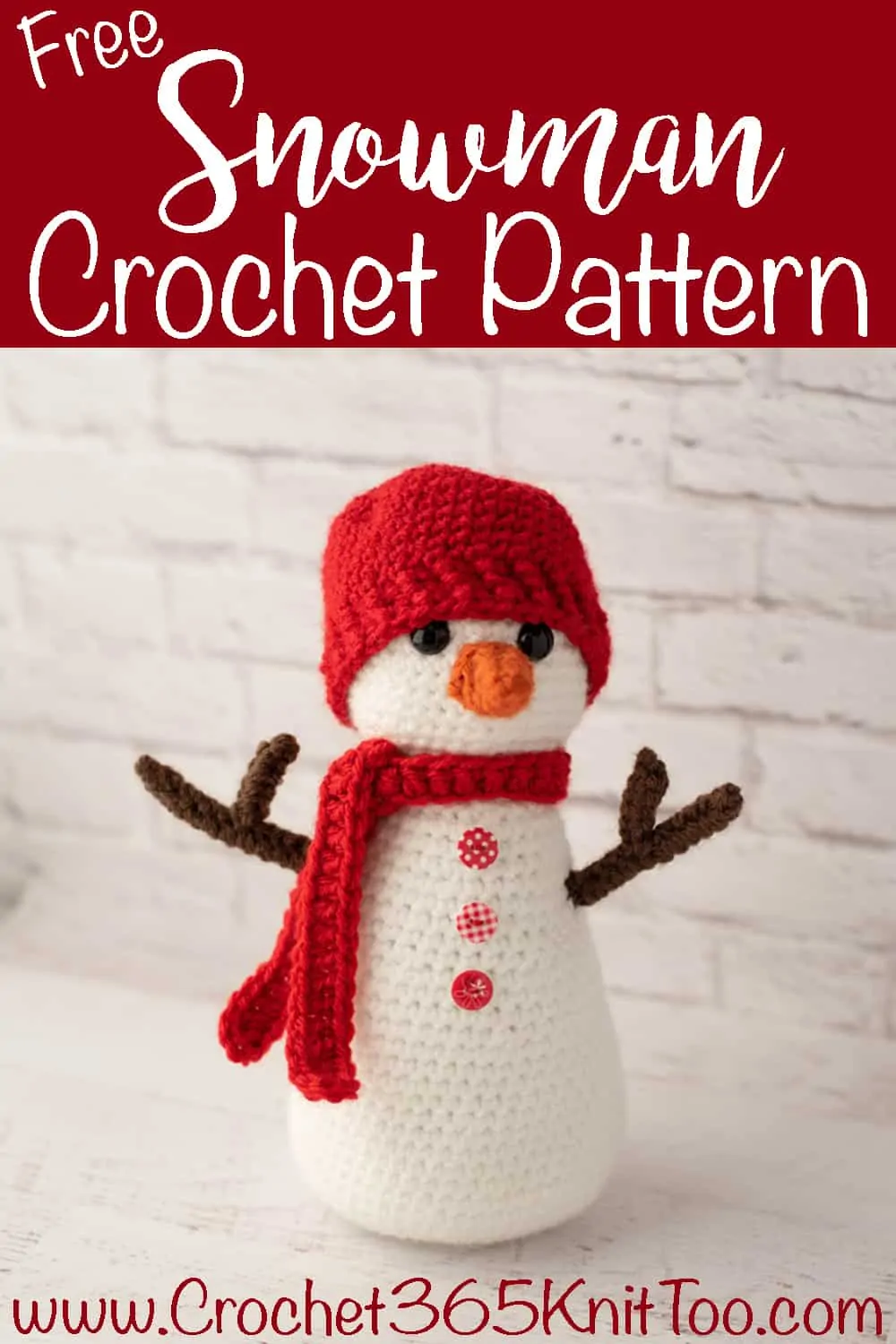 Crochet snowman with red hat and scarf, orange nose and brown twig arms