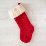 red crochet christmas stocking with white fur trim