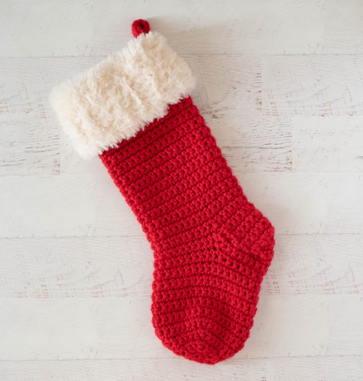 red crochet christmas stocking with white fur trim