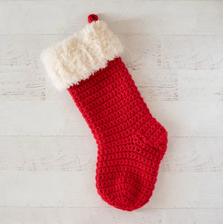 red crochet christmas stocking with white fur trim