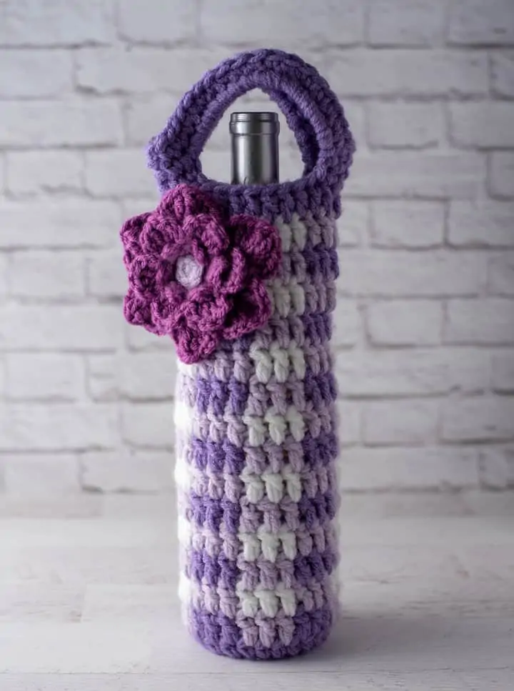 crochet purple gingham wine cozy with large purple flower