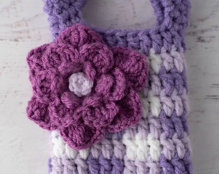 Large purple crochet flower on crochet purple gingham wine cozy