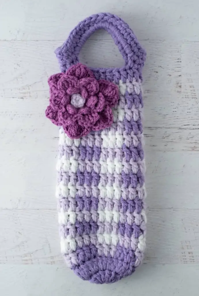 crochet purple gingham wine cozy with large purple flower