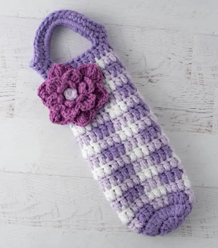 crochet purple gingham wine cozy with large purple flower