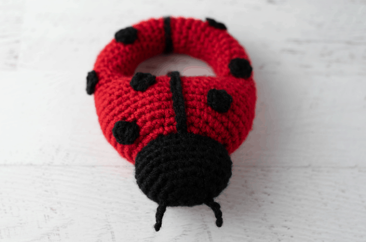 Red crochet ladybug with black spots and head