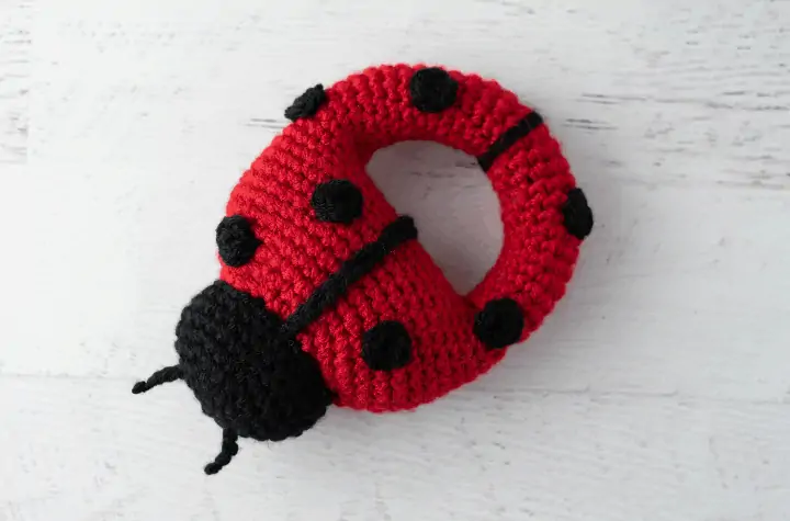 Red crochet ladybug with black spots and head