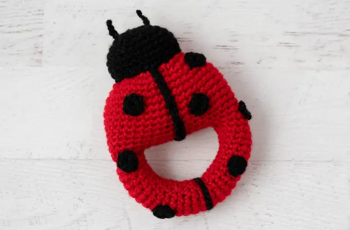 Red crochet ladybug with black spots and head