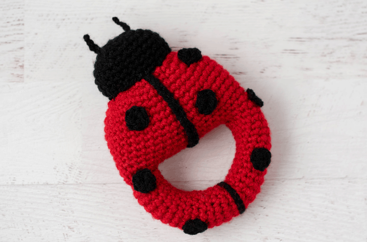 Red crochet ladybug with black spots and head