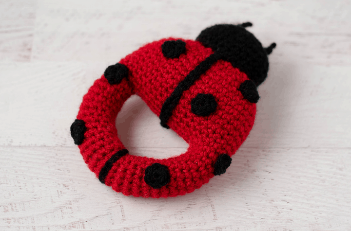 Red crochet ladybug with black spots and head