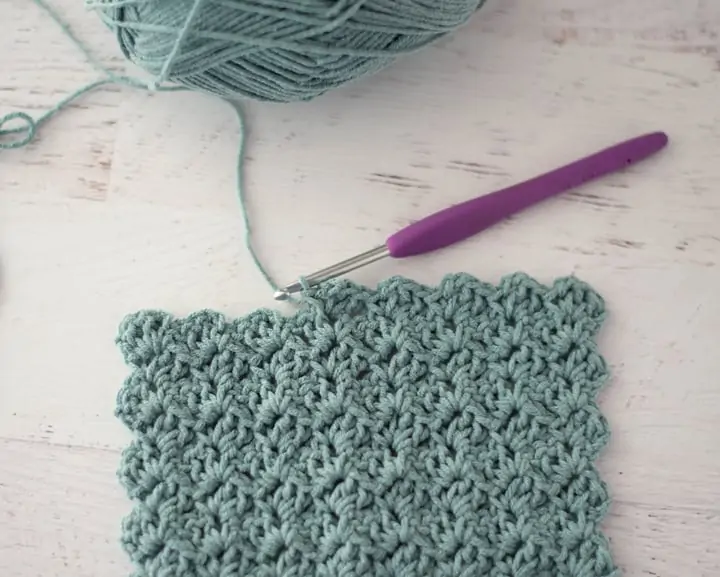 crochet tulip stitch in blue yarn with purple hook