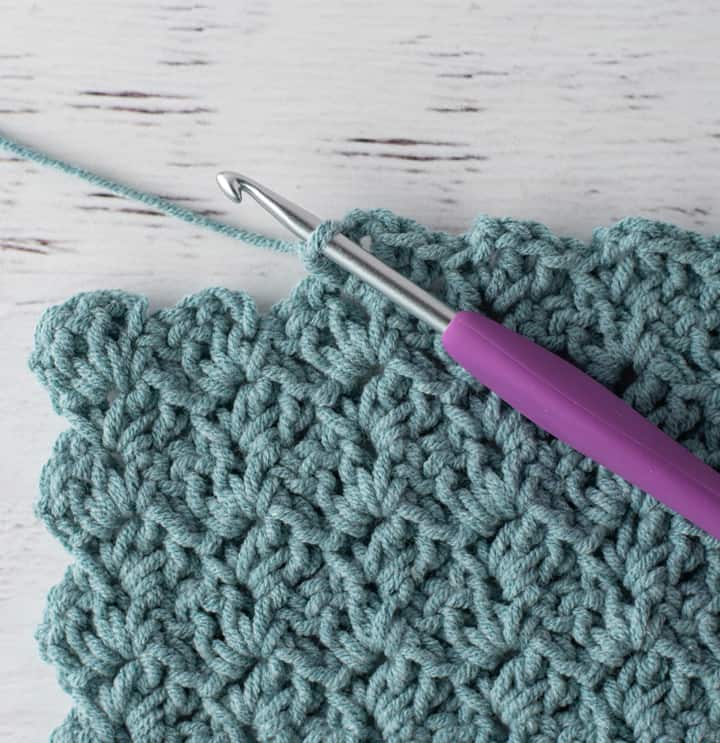 crochet tulip stitch in blue yarn with purple hook