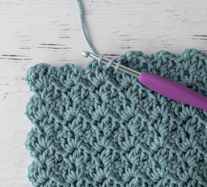 crochet tulip stitch in blue yarn with purple hook