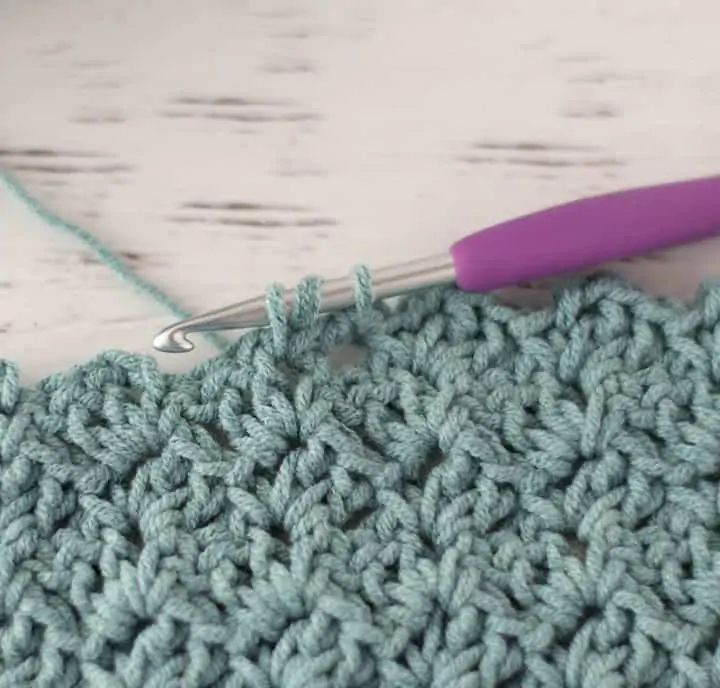 crochet tulip stitch in blue yarn with purple hook