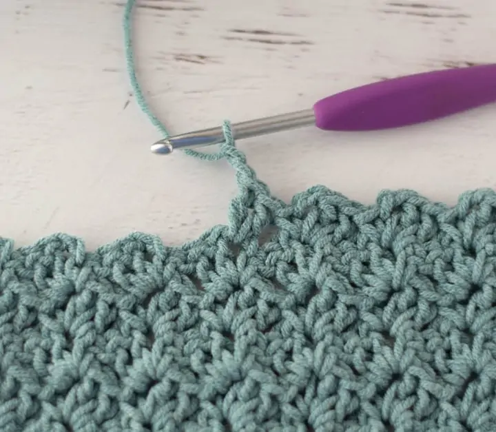 crochet tulip stitch in blue yarn with purple hook