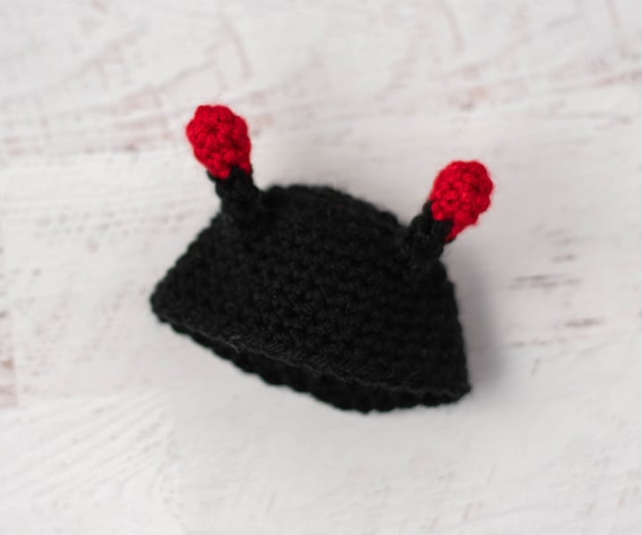 crochet black hat with ladybug antenna