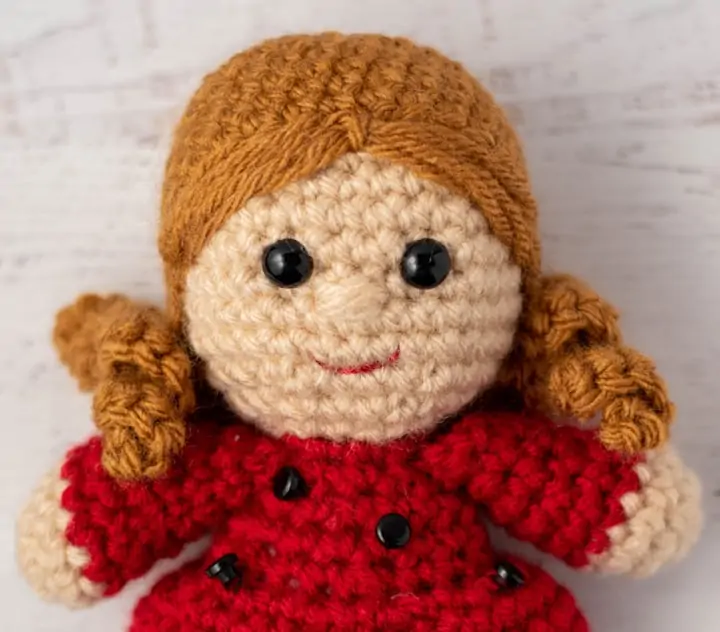 close up view of crochet doll head and hair