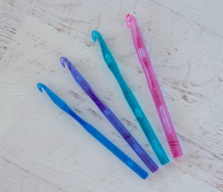 4 plastic crochet hooks in jewel colors