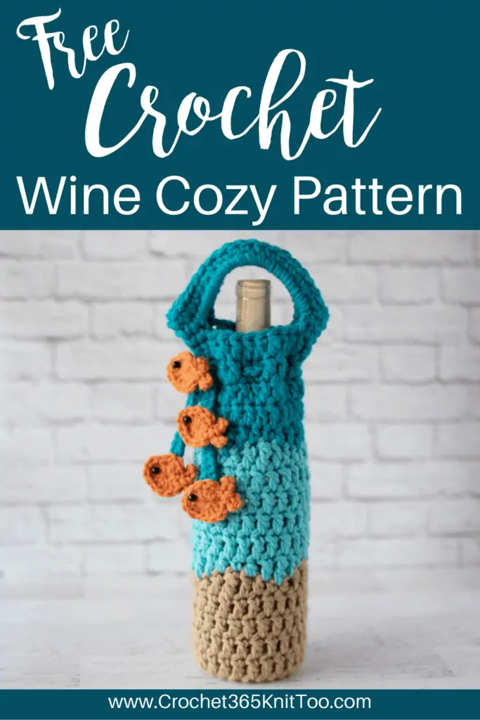 crochet wine cozy in blue, light brown with a blue tie with gold fish