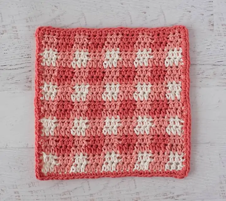 Orange plaid dishcloth on white wood table