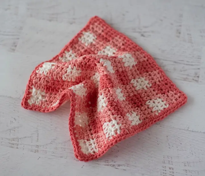 Orange plaid dishcloth on white wood table