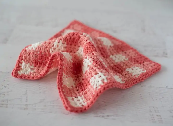 Orange plaid dishcloth on white wood table