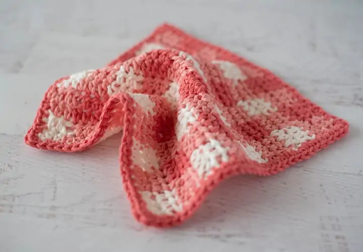 Orange plaid dishcloth on white wood table