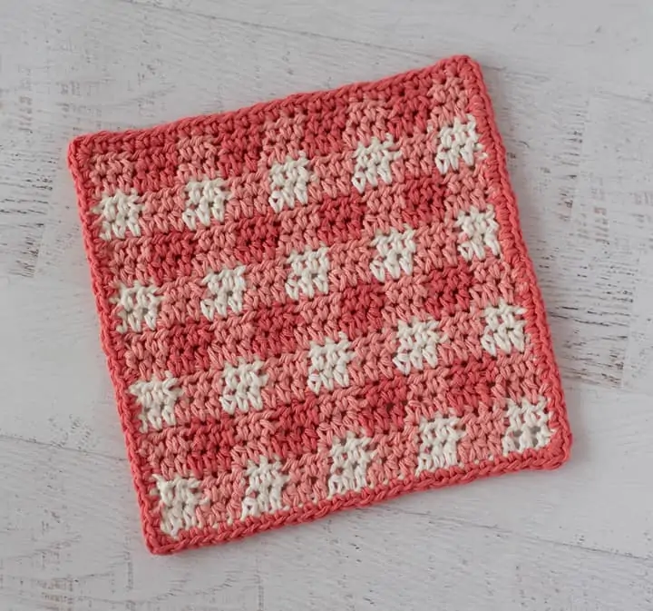 Orange plaid dishcloth on white wood table