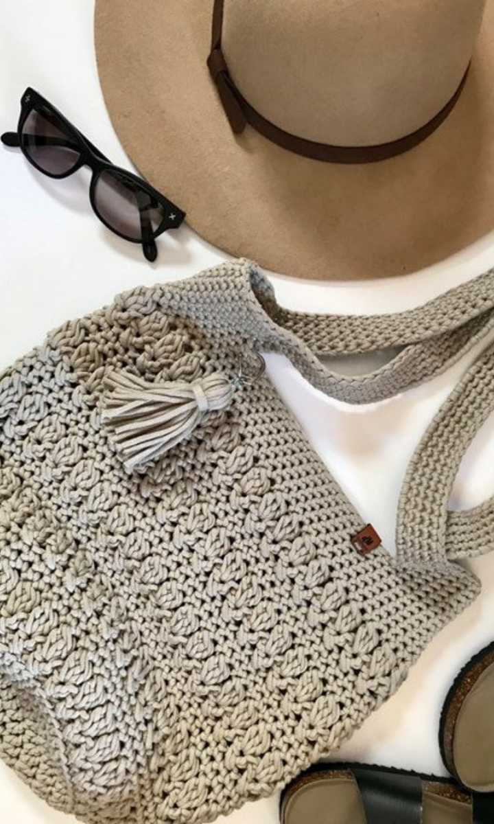 crochet grey bag with hat, sunglasses, and sandals