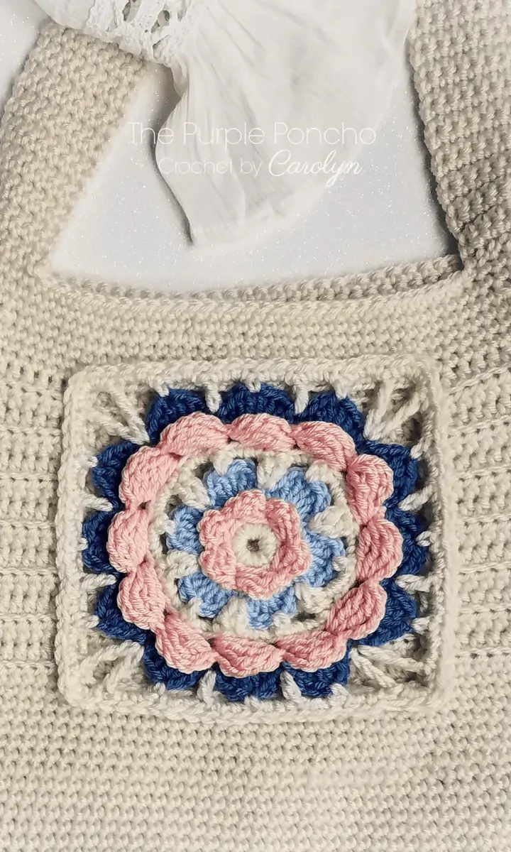 white crochet bag with flower design on it