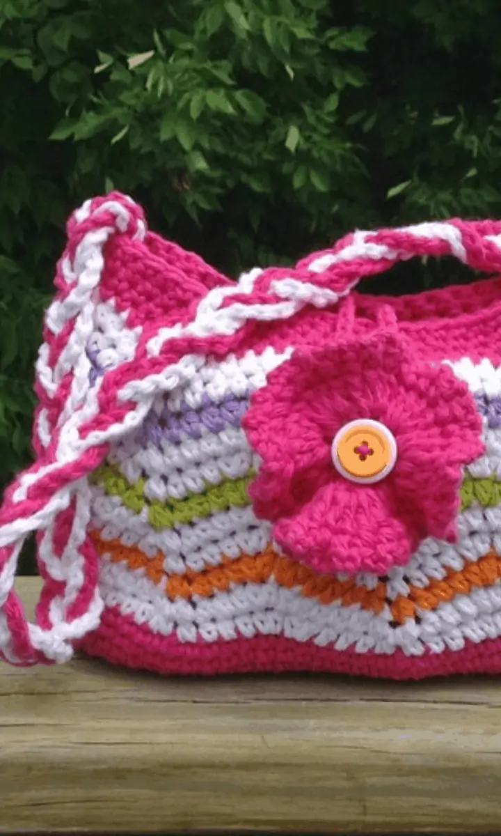 pink and white striped bag with a flower on it