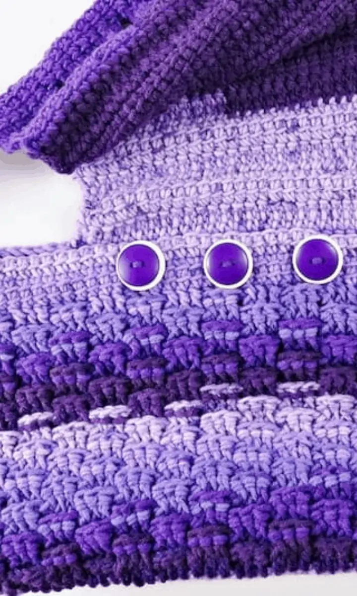 purple crochet bag with buttons on it