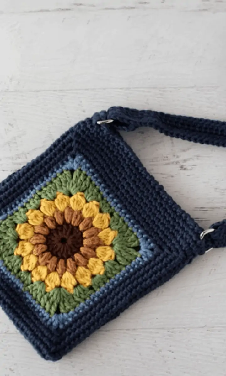 crochet navy blue bag with sunflower on it