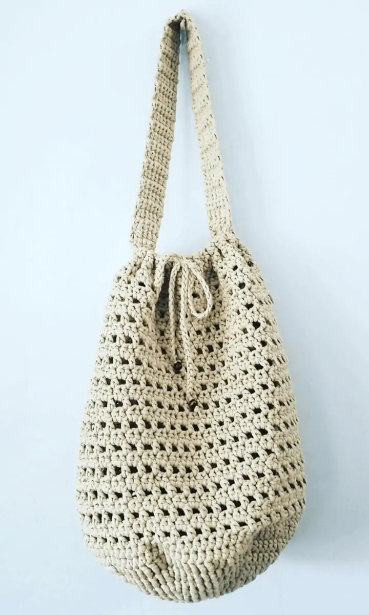 tan crochet bag hanging up