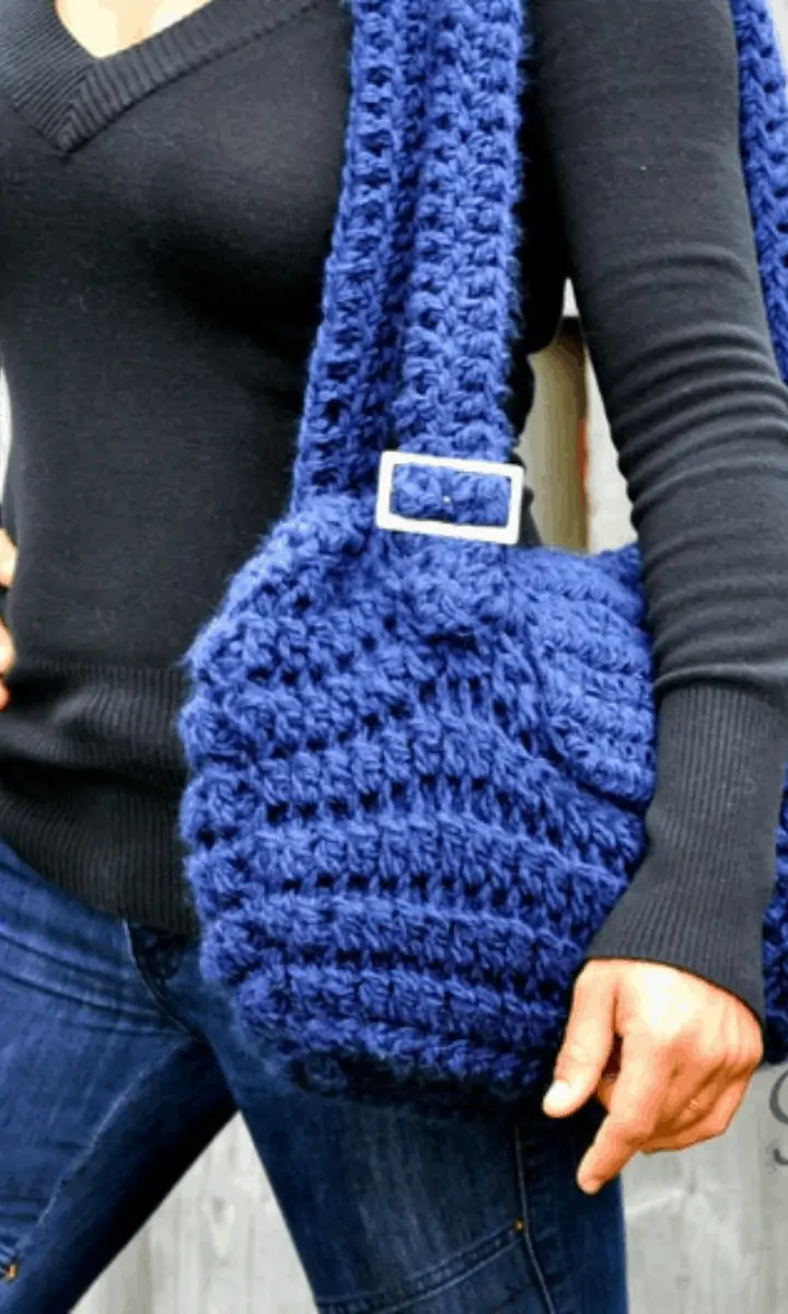 woman holding a blue crochet bag