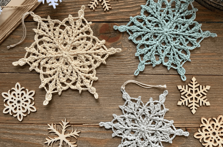 three crochet snowflakes in various colors