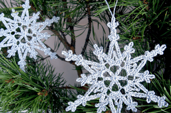 two grey crochet snowflakes
