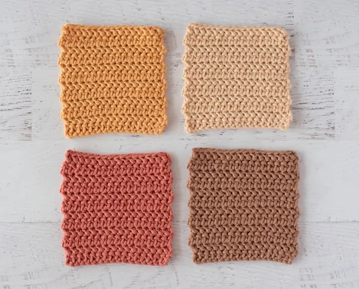 Four crochet coaster in gold, cream, rust and brown colors