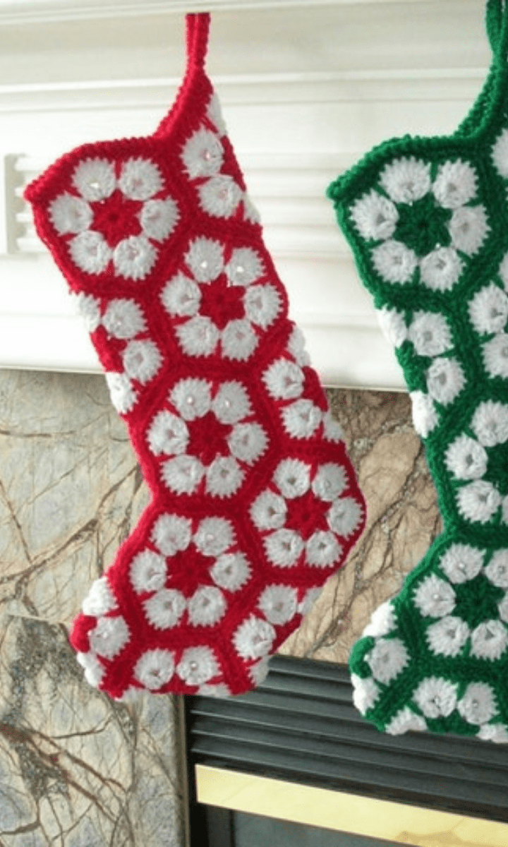 two crochet red, white, and green african flower stockings