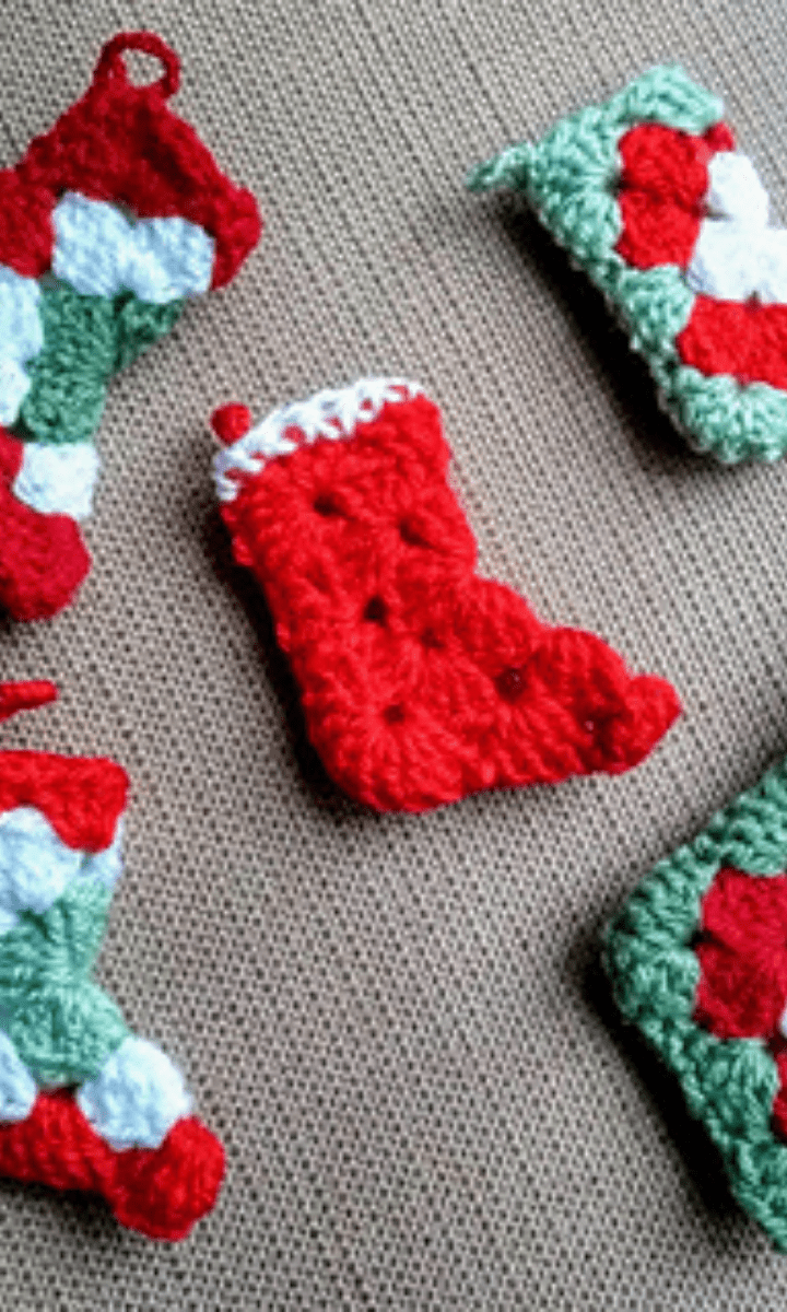 five crochet red, green, and white granny square stockings