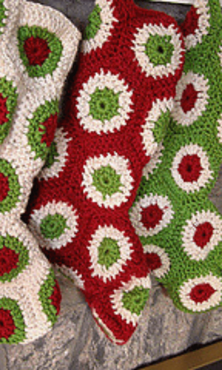 three red, white, and green crochet granny stockings