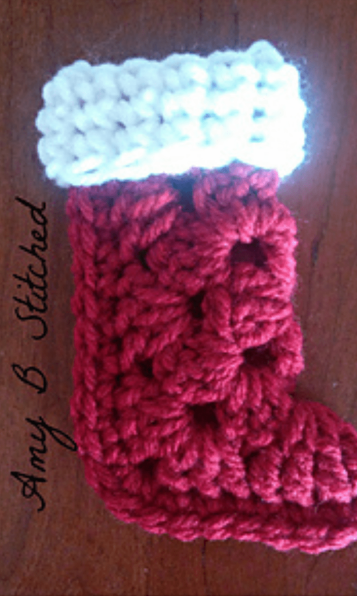 red crochet granny square stocking with white trim