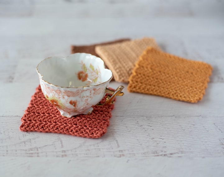 Floral antique coffee cup on a crochet coaster