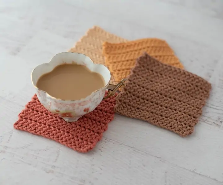 Coffee cup with coffee with 4 crochet coasters