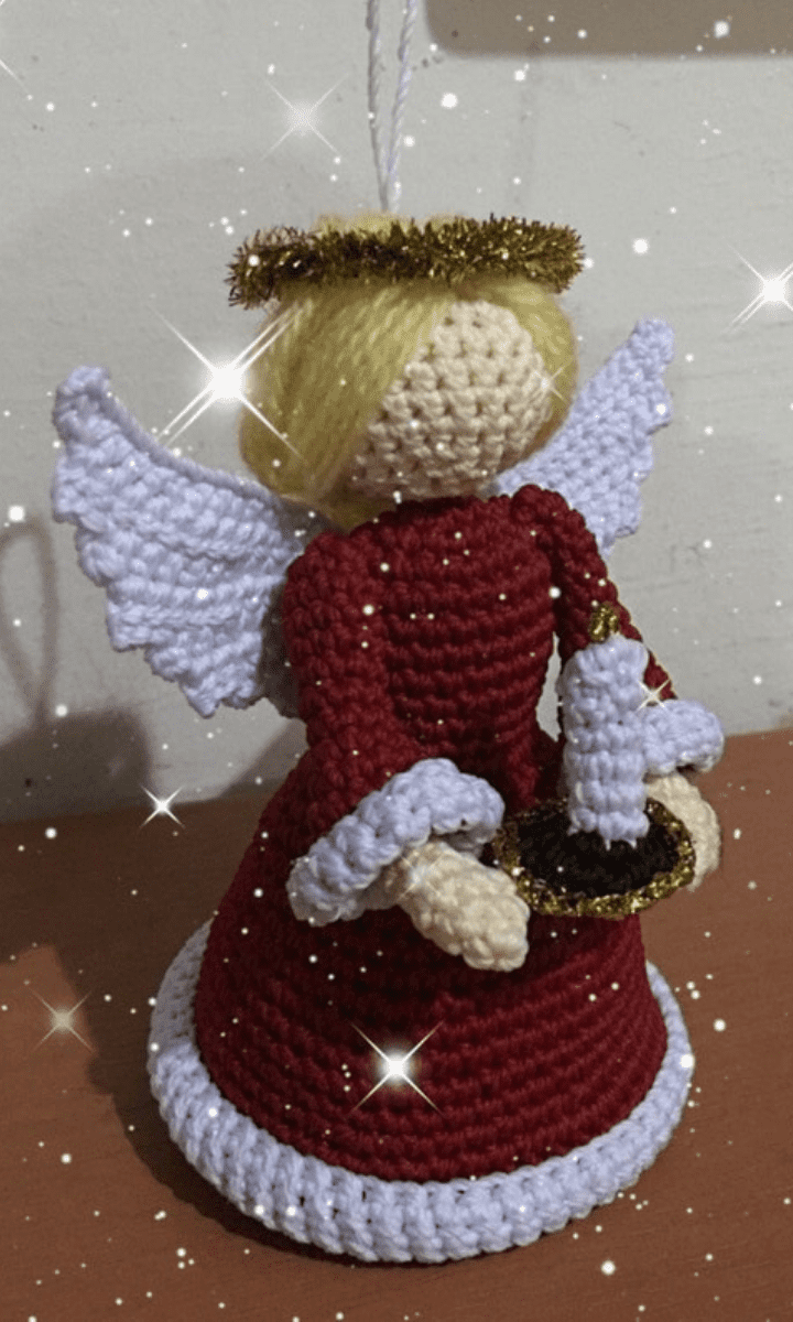 red and white crochet angel with candle