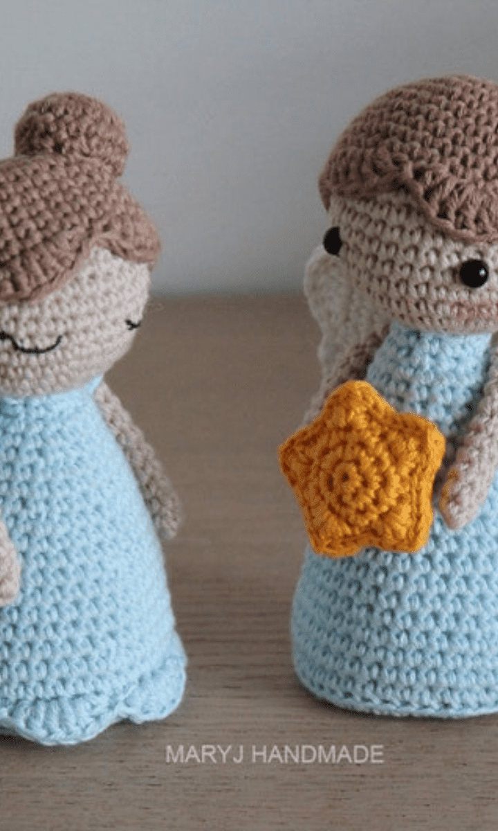 two blue crochet angels: one girl and one boy holding a star