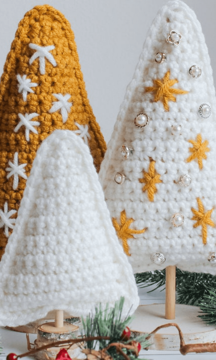 three various size gold and white christmas trees