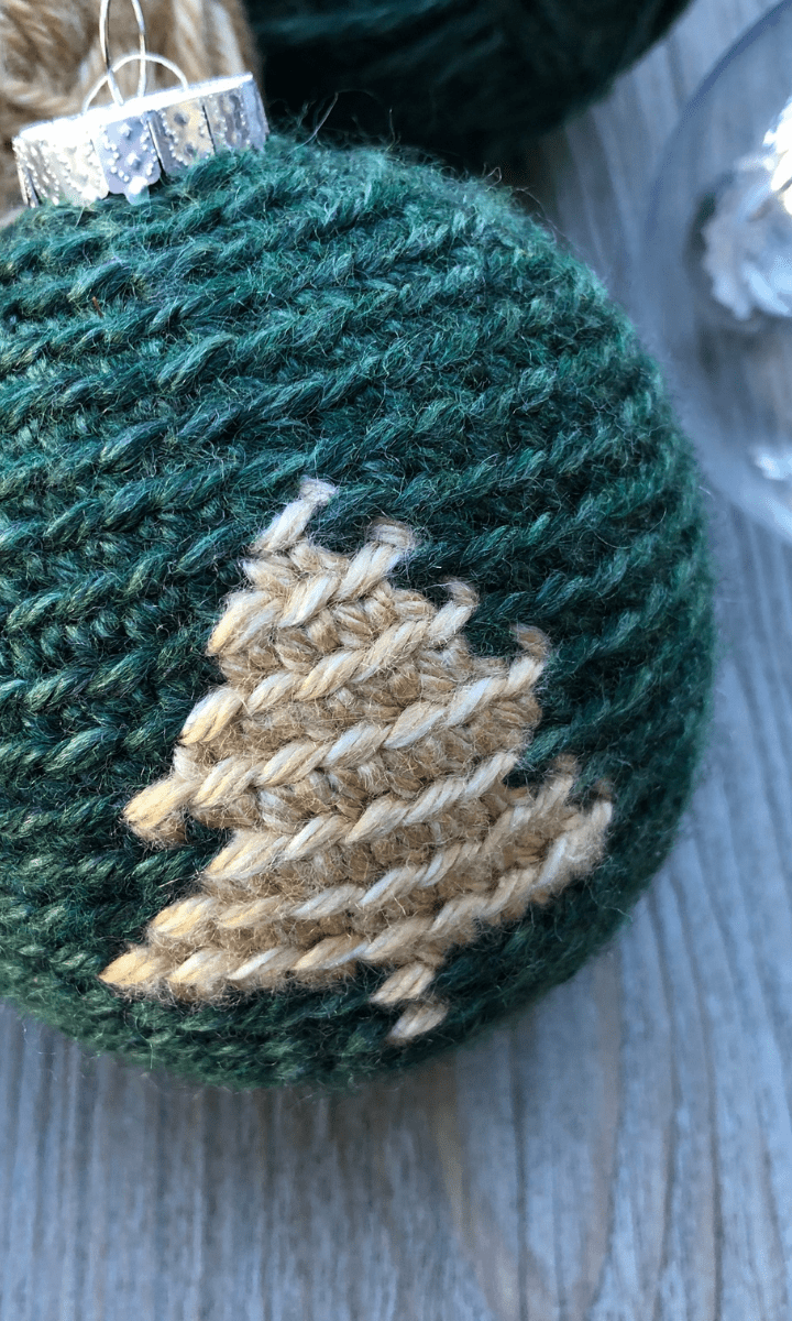 green crochet ornament with white christmas tree