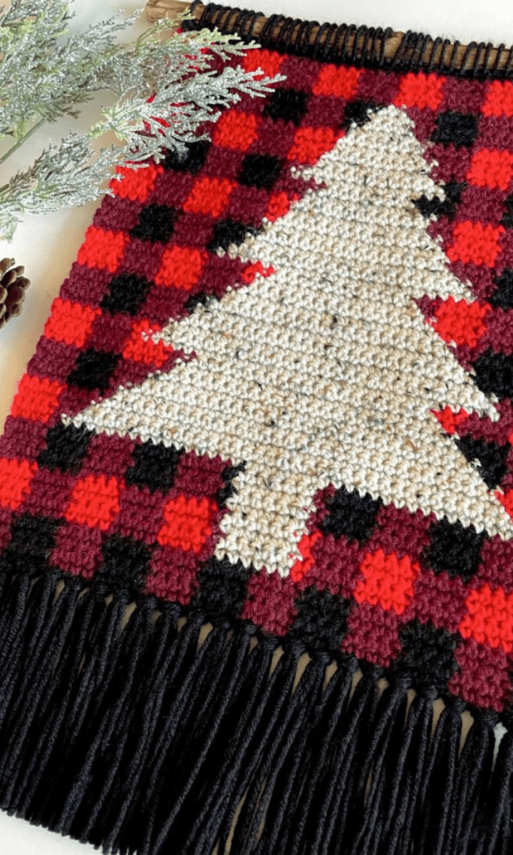 plaid crochet wall hanging with white christmas tree
