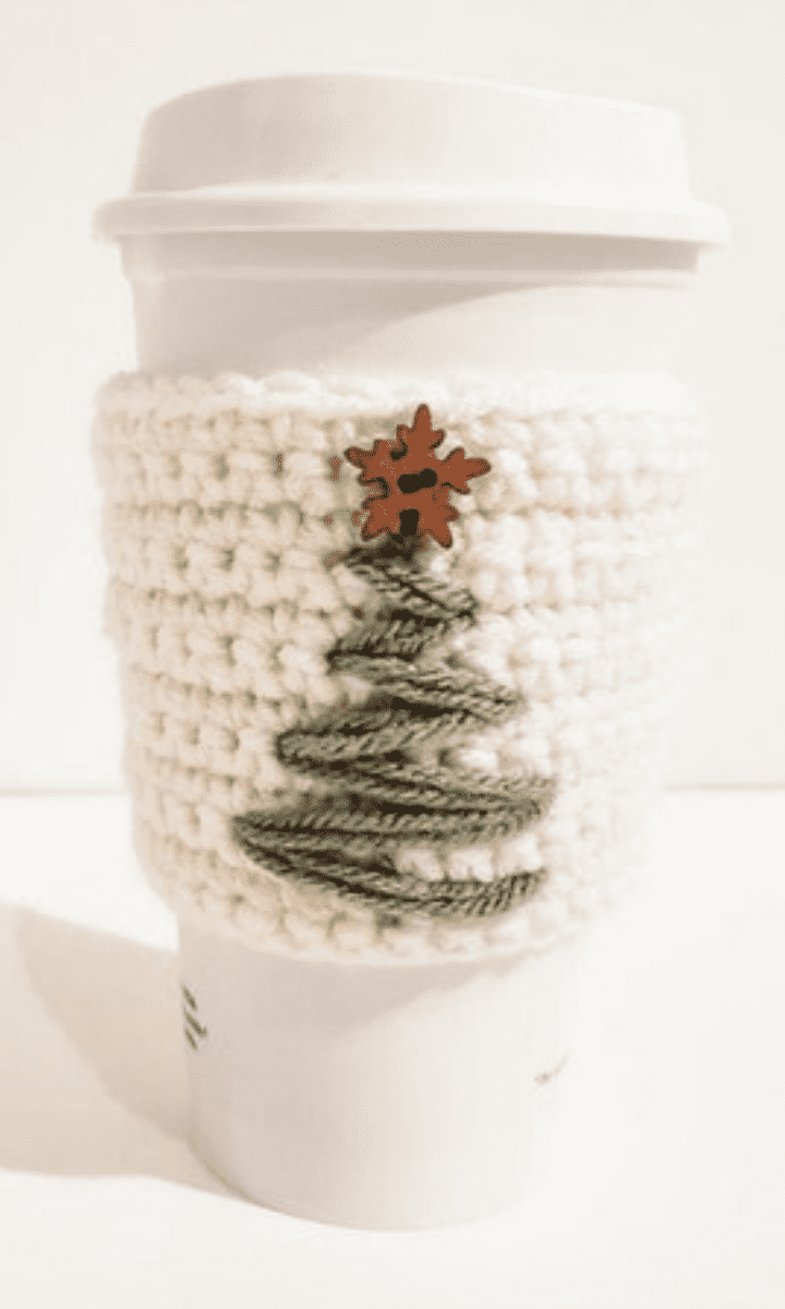 white crochet travel mug cozy with christmas tree