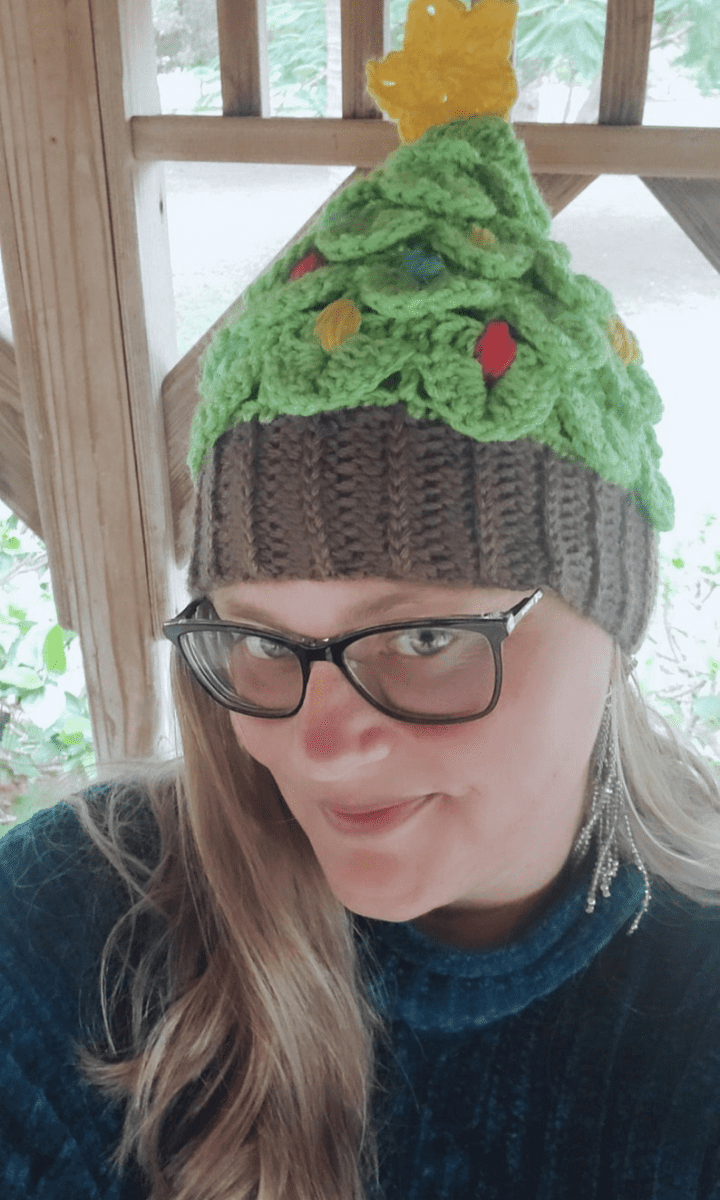 woman wearing crochet christmas tree hat